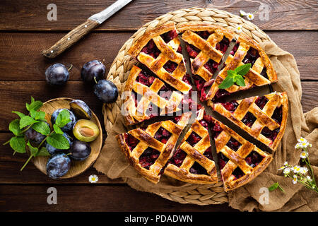 Fruit pie. Sweet pie, tart with fresh plums. Delicious cake with plums Stock Photo