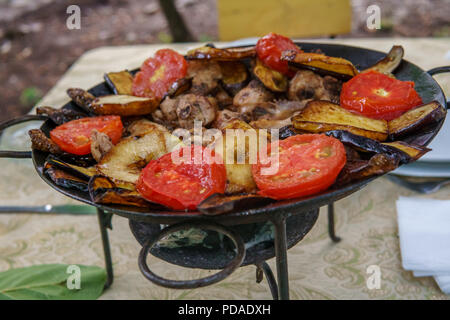 Saj kebap with mushrooms chicken. Outdoor picnic table. Stock Photo