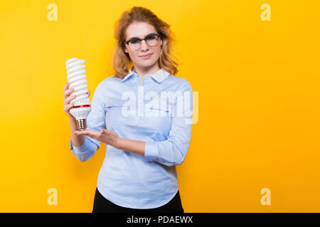 Attractive woman with energy saving bulb Stock Photo