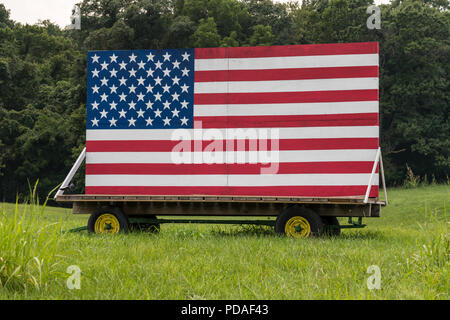 US Stars and Stripes painted on wooden boards in meadow Stock Photo