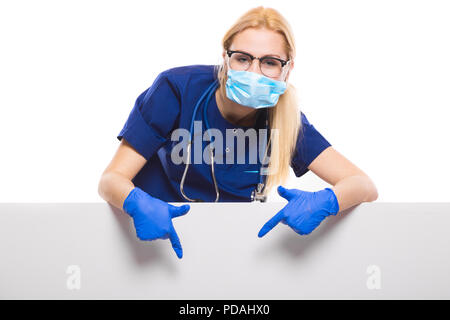Woman doctor in blue scrubs and gloves with face mask Stock Photo