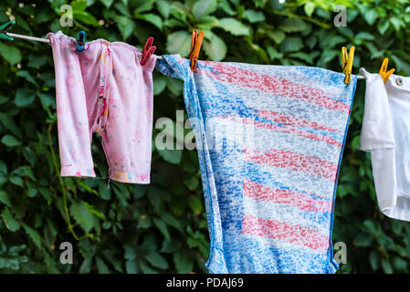 Clean baby clothes on the outdoor clothesline Stock Photo