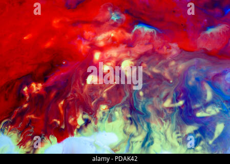 Abstract liquid milk flowing pattern like nebulae in the universe with different colours of white, blue, red and pink Stock Photo