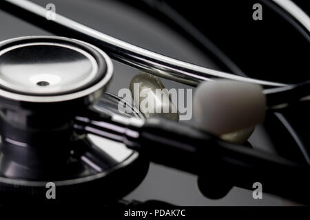 Pharmaceutical medicine and health care concept with stethoscope and prescription pills close up. Macro of medical equipment. Stock Photo