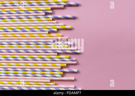 multicolored paper straws on pink background for party.Colorful drinking strawsisolated. Abstract a colorful of paper straws used for drinking water or soft drinks. Copy space Stock Photo