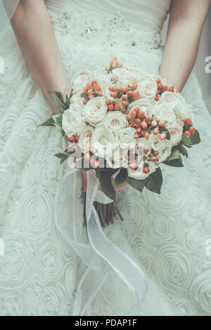 Close up view of beautiful colorful wedding bouquet in the hand of a bride and symbol of love Stock Photo