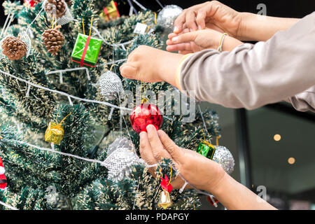 Father and son decorating Christmas tree at home. Stock Photo