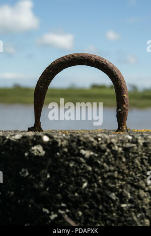 Metal mooring hoop by a lake Stock Photo