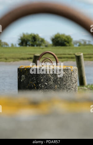 Row of mooring hoops by a lake  Stock Photo