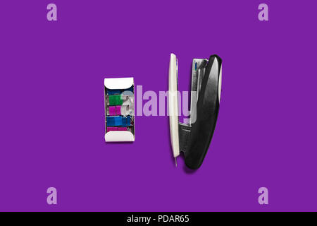 black stapler with box of braces on a purple surface Stock Photo