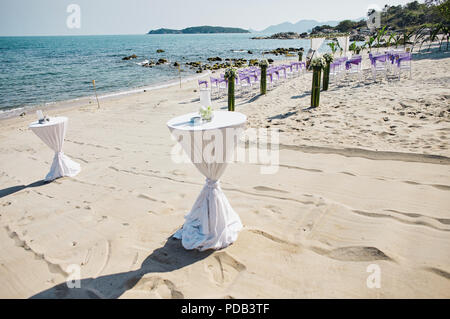 White cloth decorating snack, glasses table, beach wedding venue at seaside with panoramic ocean view Stock Photo