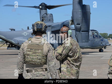 Chief Master Sgt. of the Air Force Kaleth O. Wright speaks with U.S. Air Force Senior Airman Michael Ricci, 100th Logistics Readiness Squadron Forward Area Refueling Point specialist, during a Forward Area Refueling Point exercise at RAF Mildenhall, England. Aug. 2, 2018. During the visit, Wright met with Airmen from multiple units to ask about their needs and see how they accomplish the mission. (U.S. Air Force photo by Senior Airman Luke Milano) Stock Photo