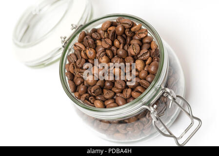 Roasted coffee beans in clip top storage jar viewed from above on white background Stock Photo