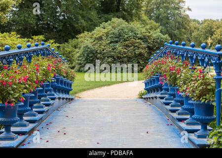 old blue bridge in the Fuerst Pueckler park in Bad Muskau Germany Stock Photo