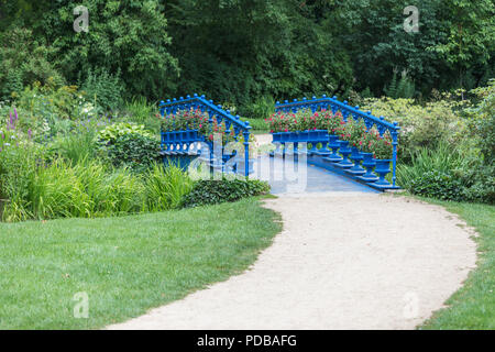 old blue bridge in the Fuerst Pueckler park in Bad Muskau Germany Stock Photo