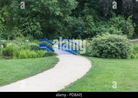 old blue bridge in the Fuerst Pueckler park in Bad Muskau Germany Stock Photo