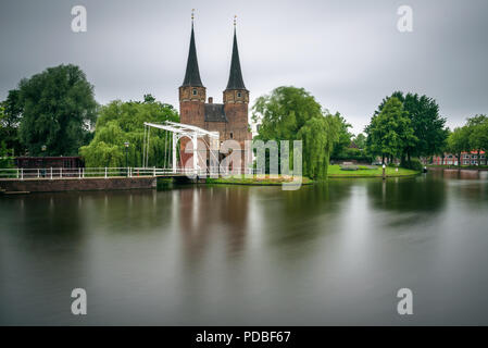 Eastern gate also known as Oostport, old canal and historic drawbridge in Delft, Netherlands. Long exposure. Stock Photo