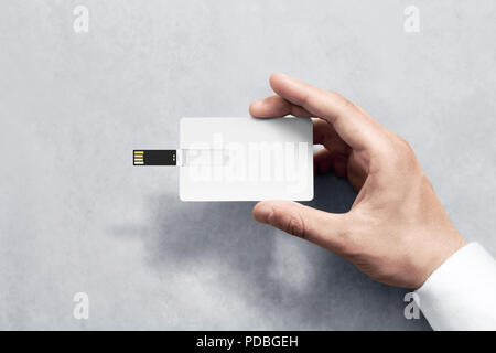 Blank white plastic wafer usb card design mockup holding hand. Visiting flash drive namecard mock up. Call-card disk souvenir presentation. Flat credit stick adapter. Bussiness favor in mans arm Stock Photo