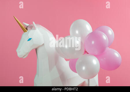 Party decoration with unicorn and balloons isolated on pink Stock Photo