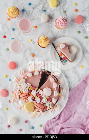 flat lay with birthday cake, marshmallows, candies, sweet cupcakes and milkshakes Stock Photo