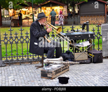 Older man busking playing saxophone in old town Prague, Czech Republic Stock Photo