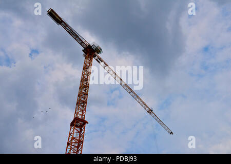 Looking up at single high rise tower construction crane Stock Photo