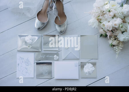 top view of wedding invitations with bridal shoes and bouquet on floor Stock Photo