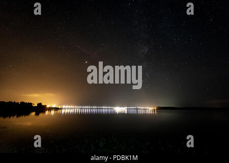 Night photography in the Gabriel and Galan reservoir, the artificial lights are from the dam of the marsh. Extremadura. spain. Stock Photo