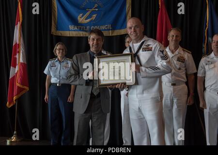 180803-N-DA737-0123 SEATTLE (Aug. 3, 2018) Hospital Corpsman 1st Class Thomas Geisinger is awarded Naval Hospital Bremerton Sailor of the Year during a Seattle Navy League Sea Services Luncheon as part of Seattle’s Seafair Fleet Week. Seafair Fleet Week is an annual celebration of the sea services wherein Sailors, Marines and Coast Guard members from visiting U.S. Navy and Coast Guard ships and ships from Canada make the city a port of call. (U.S. Navy photo by Mass Communication Specialist 2nd Class Jonathan Jiang/Released) Stock Photo
