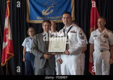 180803-N-DA737-0125 SEATTLE (Aug. 3, 2018) Master-at-Arms 1st Class Shane R. McClelland is awarded Naval Hospital Bremerton Sailor of the Year during a Seattle Navy League Sea Services Luncheon as part of Seattle’s Seafair Fleet Week. Seafair Fleet Week is an annual celebration of the sea services wherein Sailors, Marines and Coast Guard members from visiting U.S. Navy and Coast Guard ships and ships from Canada make the city a port of call. (U.S. Navy photo by Mass Communication Specialist 2nd Class Jonathan Jiang/Released) Stock Photo