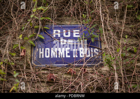 Old blue and white enamel street sign for 'Rue de Homme de Bois', Honfleur, Normandy, France Stock Photo