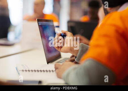 Hacker at laptop coding for charity at hackathon Stock Photo
