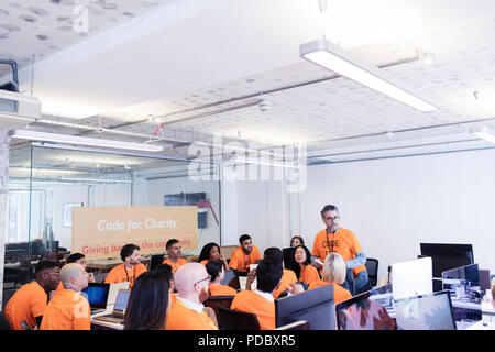 Hackers coding for charity at hackathon Stock Photo