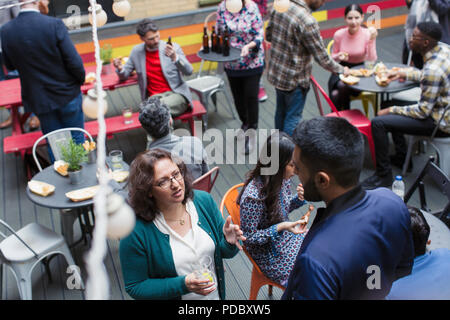 Friends socializing at party on patio Stock Photo