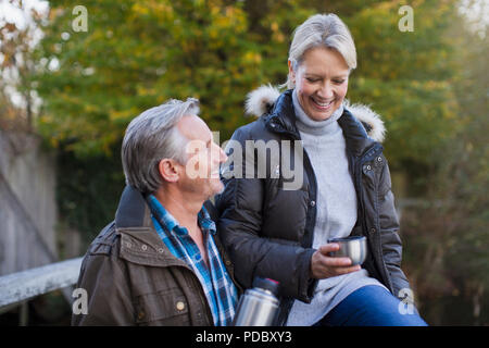 Mature couple drinking coffee in park Stock Photo