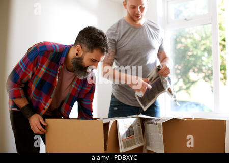 Male gay couple packing, moving out Stock Photo