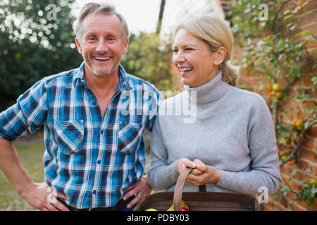 Portrait happy, carefree mature couple in garden Stock Photo