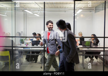 Business people walking and talking in office Stock Photo