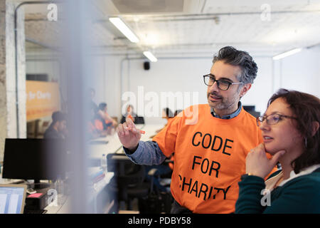 Hackers planning, coding for charity at hackathon Stock Photo