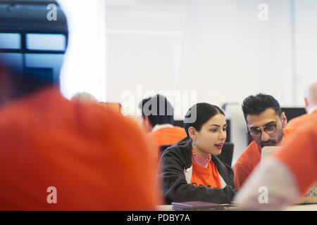 Focused hackers coding for charity at hackathon Stock Photo