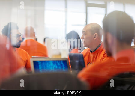 Hackers coding for charity at hackathon Stock Photo