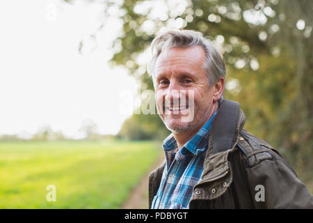 Portrait smiling, confident senior man in park Stock Photo