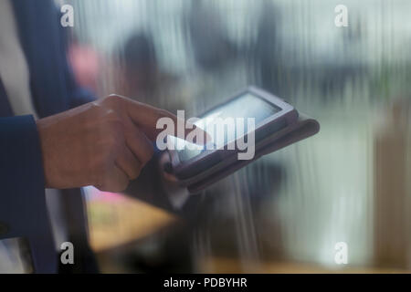 Close up businessman using digital tablet Stock Photo