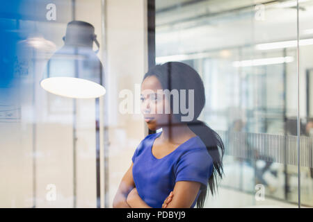 Focused, determined businesswoman in office Stock Photo