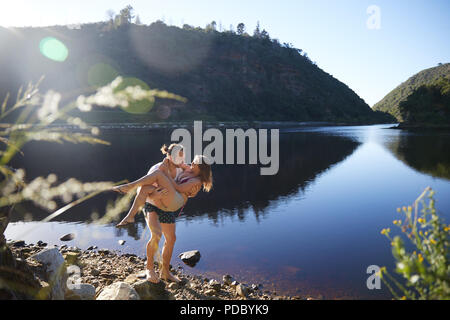 Romantic, carefree couple at sunny summer lake Stock Photo