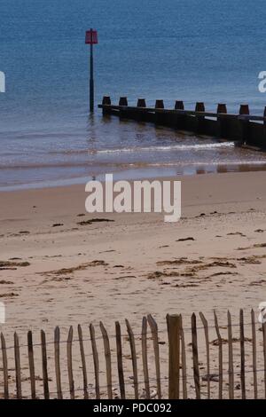 Wooden Groynes along Dawlish Warren Beach on a Calm, Sunny Summers Day. Devon, UK. Stock Photo