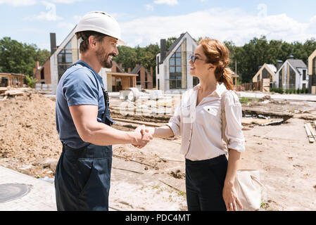 Joyful positive people shaking hands Stock Photo