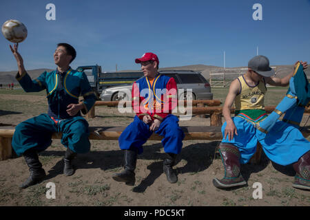 Buryat men play football near sacred mountain Erd located 2 km from Baikal lake, Irkutsk oblast, Russia Stock Photo