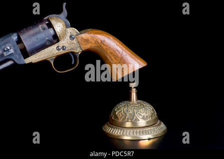 Need service now, ringing service bell and cowboy pistol with room for your type, Stock Photo