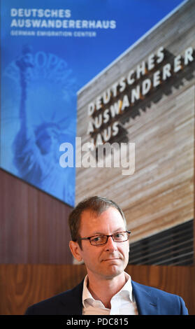 08 August 2018, Germany, Bremerhaven:  Martin Günthner (SPD), Senator for Economics, Labour and Ports, Bremen, speaks at a press conference on the future of the Museum Deutsches Auswandererhaus. The city of Bremerhaven and the non-profit museum have agreed to continue their cooperation until 2035. Photo: Carmen Jaspersen/dpa Stock Photo